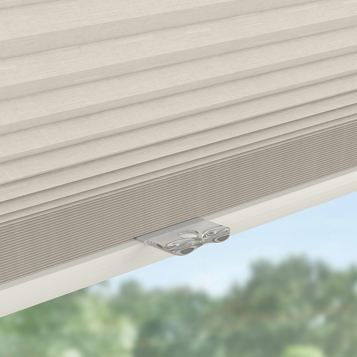 Detailed close up shot of the handle for a cordless lift cellular shade.