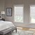 Lifestyle bedroom scene with Contemporary decor featuring the Motorized Zebra Shades in the Warm Jewel color.