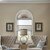 Vignette of a transitional living room featuring the light filtering cellular arch in the Rye color.
